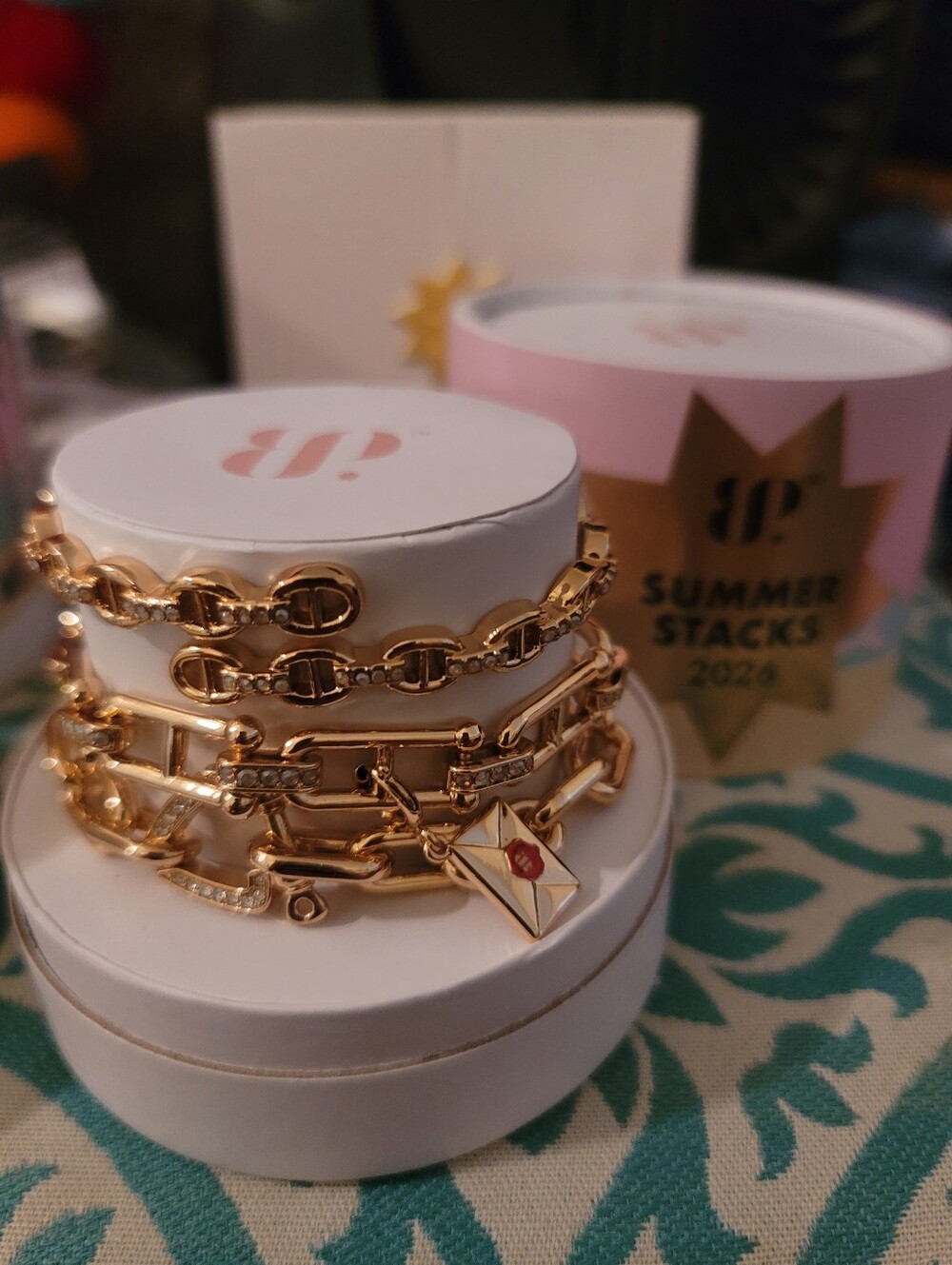BP 2026 Summer Stacks Gold Bracelet Stack with Envelope Charm. Founder's Letter